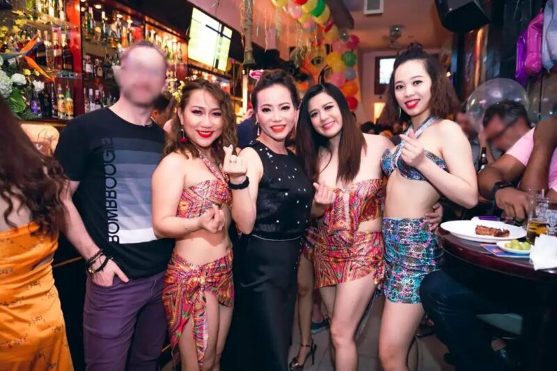 About 3 the-owner-of-kims-tavern-and-her party-girls-showing-love-sign