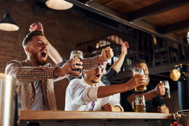 Guys Celebrating victory inside Kim's Tavern Lady Bar at being good for your health