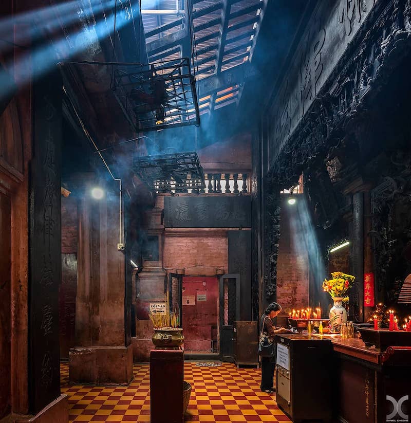 Gods, Legends, and Turtles: A Visitor’s Guide to the Jade Emperor Pagoda 2 The Interior of Jade Emperor Pagoda with a woman praying in Ho Chi Minh City